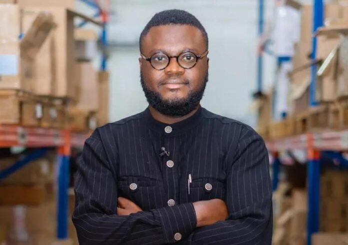 Gregory Rockson, co-founder and CEO of mPharma, standing in an mPharma warehouse as the company expands access to affordable medicines across Africa.